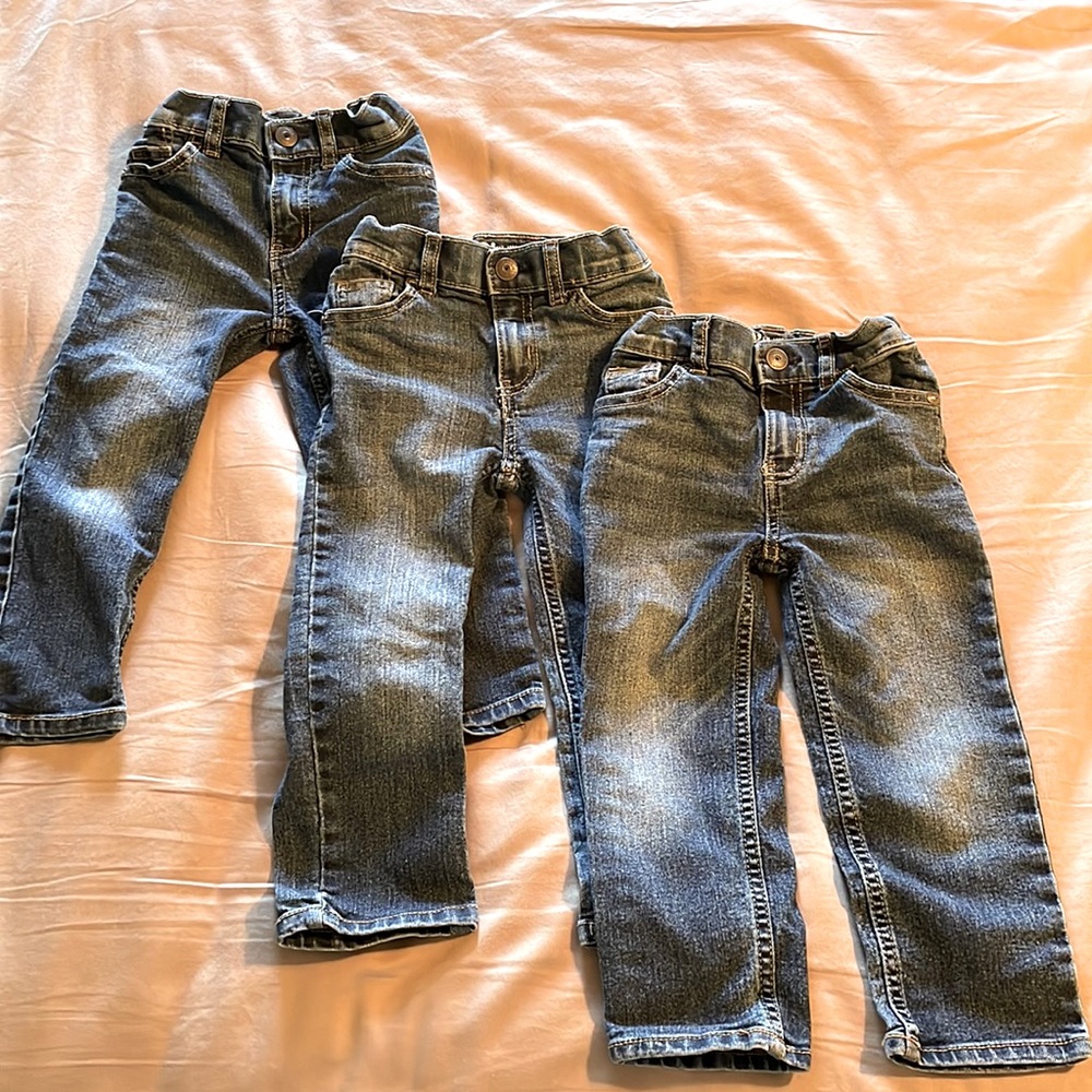 THREE pairs of 3T B’gosh jeans.
